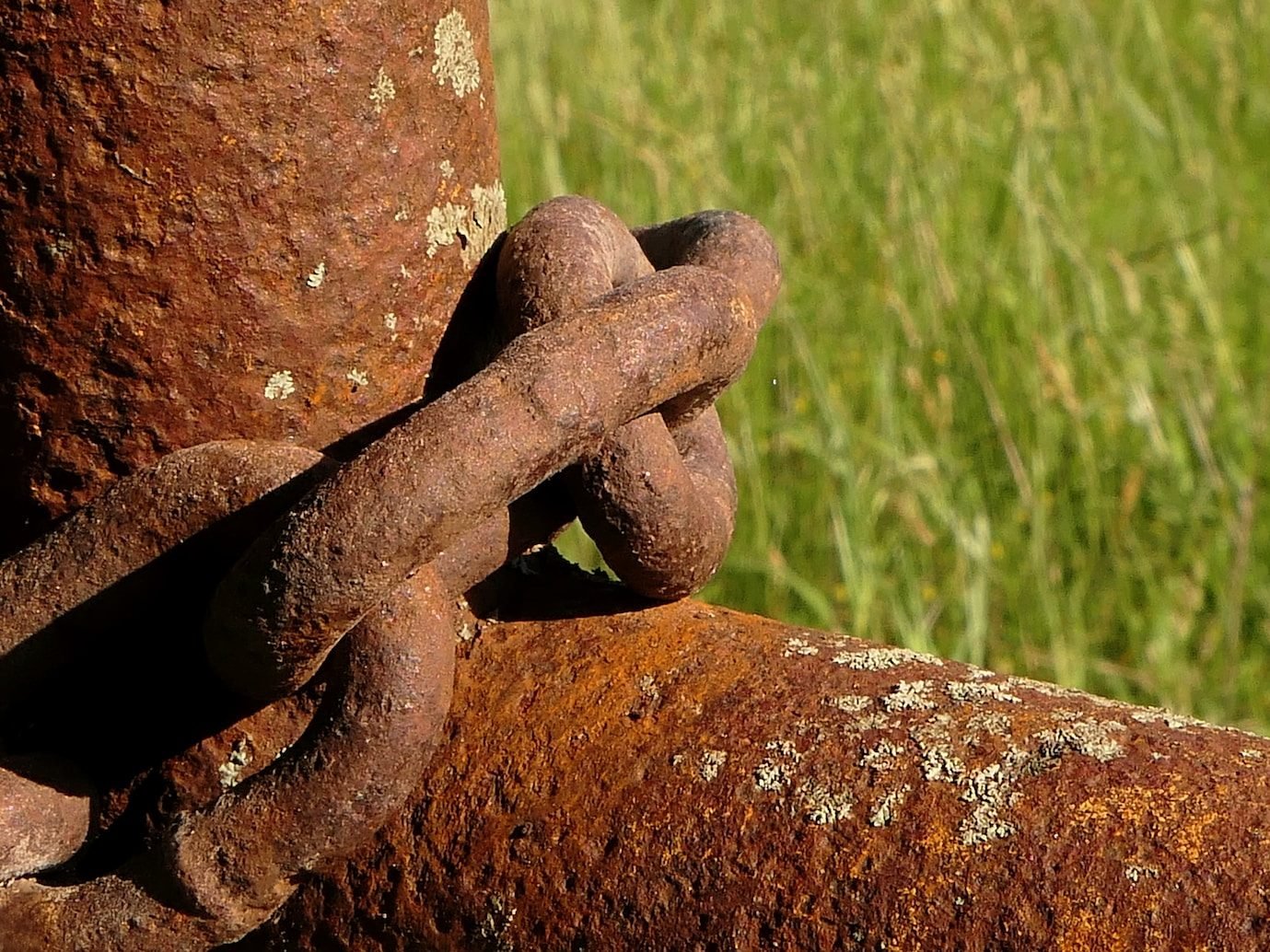 a rusted chain is attached to a rusty pole