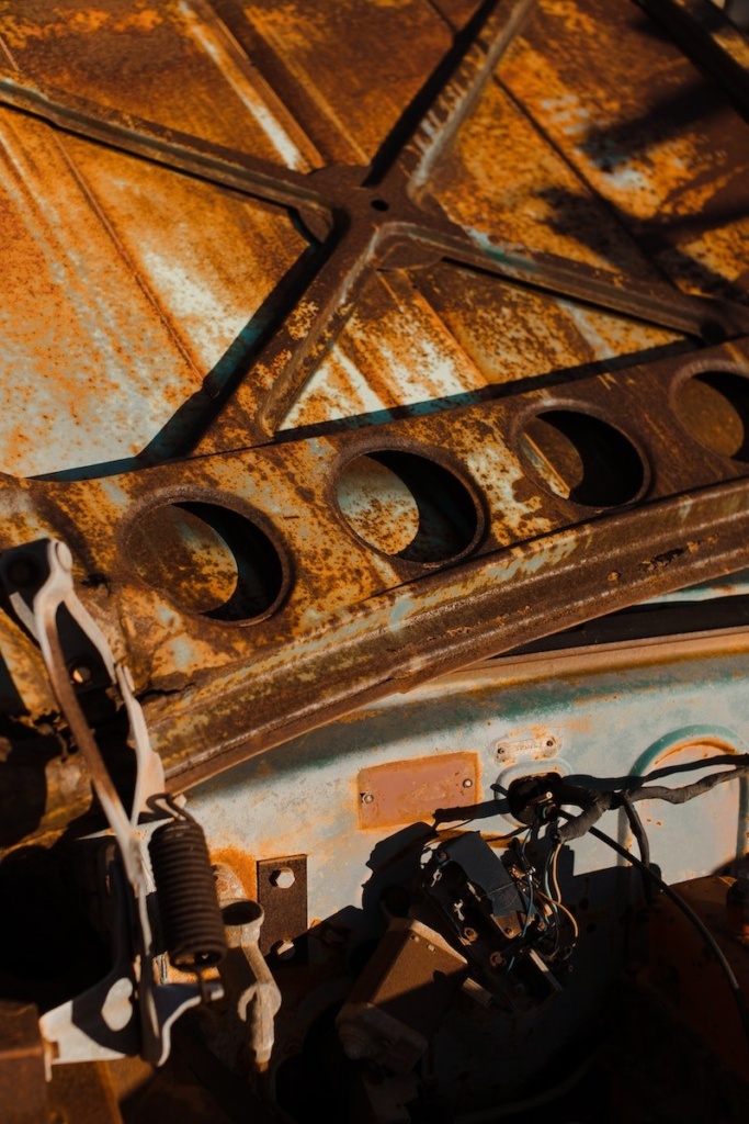 Inner surface of old car hood in corrosion and details in rusty stains